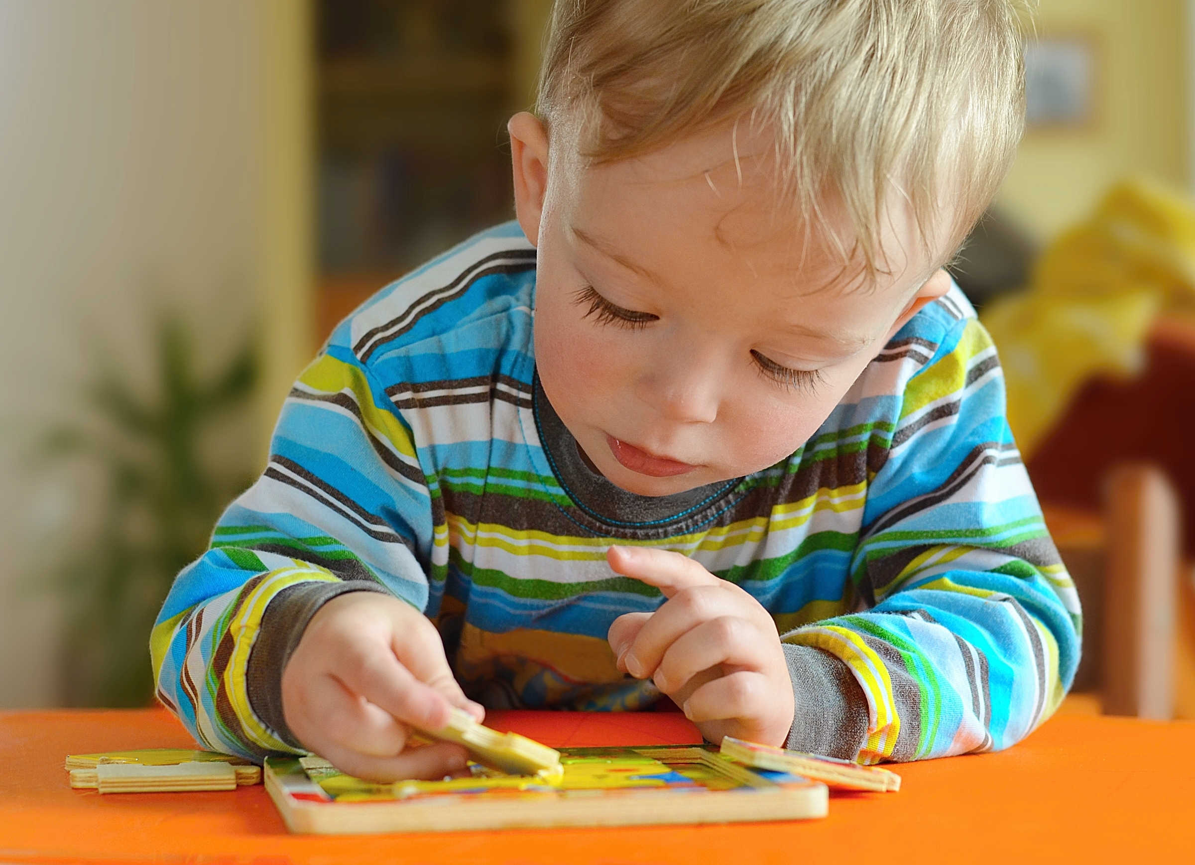 Little boy doing puzzle